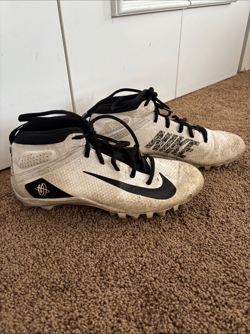 White and black Nike Alpha Huarache 7 Varsity lacrosse cleats